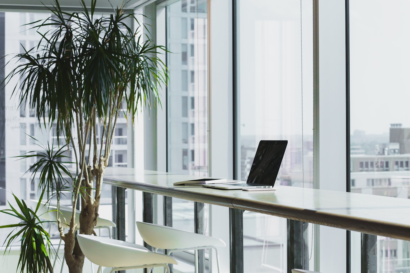 A bright, minimal modern workspace by floor-to-ceiling windows